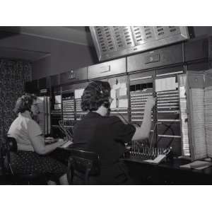 Two Women Wearing Headsets, Working on Telephone Switchboard 