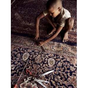Child Clipping and Finishing Carpet, Varanasi (Benares), Uttar Pradesh 