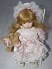 Porcelain Doll with Teddy Bear in Rocking Chair Collectible