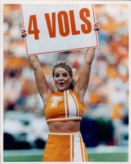   cheerleader Britney Rothman holding up the 4 Vols sign durning a game